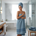 Woman wrapped in plush dusty blue zero-twist cotton bath towel after shower
