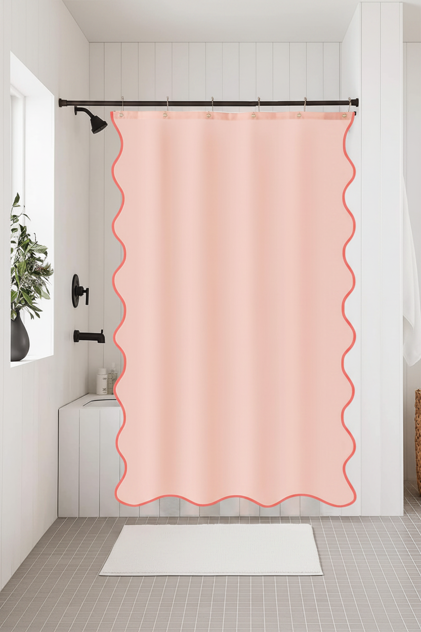 Blush peach shower curtain with coral wavy scalloped trim in a modern farmhouse bathroom with white shiplap walls and matte black fixtures
