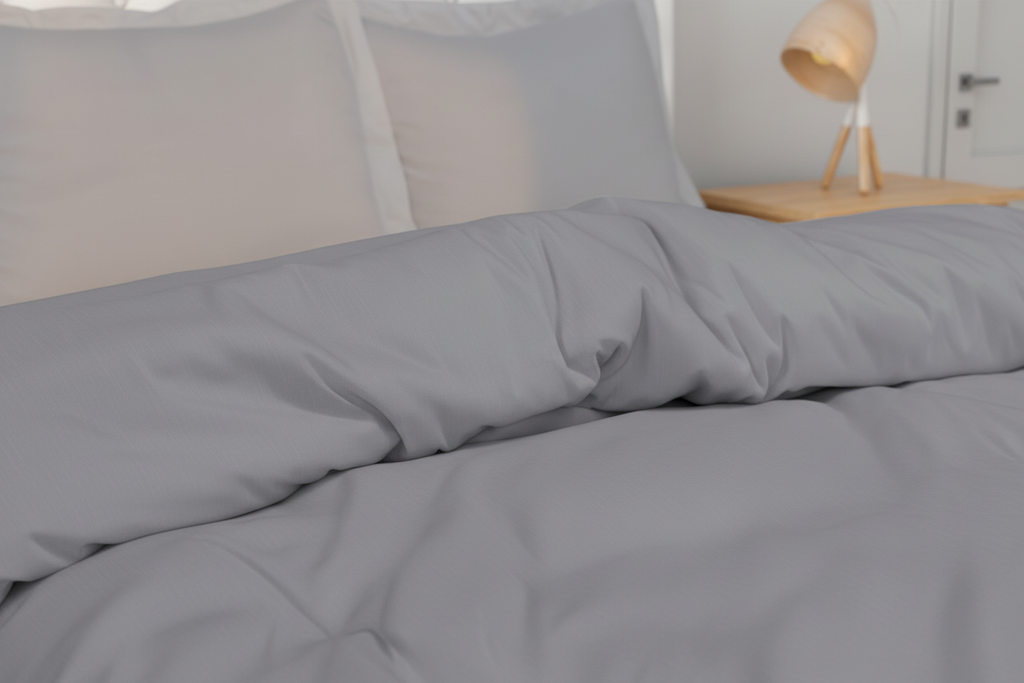 Detail of silver grey duvet cover pillowcase showing smooth brushed microfibre and clean edge finish