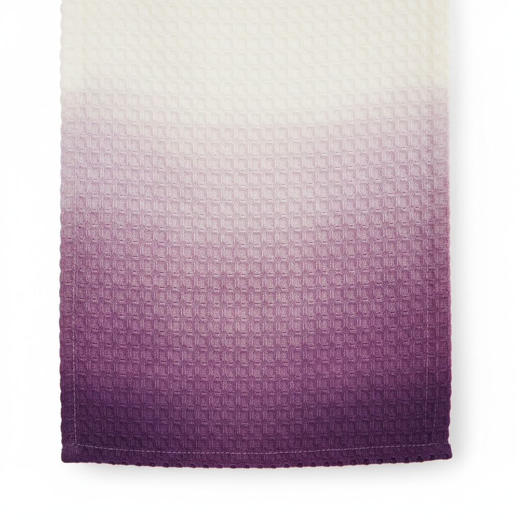 Close-up of purple ombre waffle weave fabric showing white to deep purple gradient and textured pattern