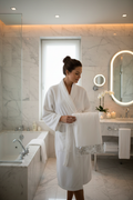 Sinatra 3-Piece Towel Set - woman in bathrobe holding white bath towel with silver sequin border