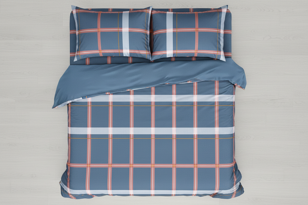 Overhead top-down view of bed made with blue plaid cotton sheet set and two pillowcases