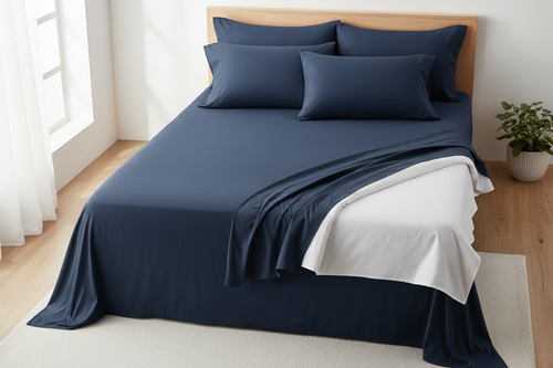 Navy bamboo blend cooling king sheet set flat lay on king bed